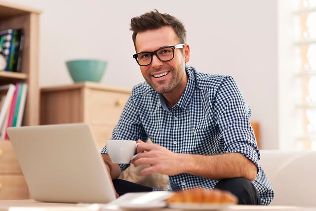 Man on laptop smiling